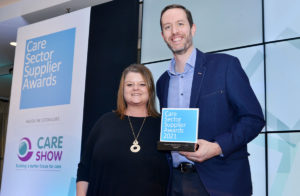 Unique IQ's CEO & Founder, David Lynes, with Operations Director, Cheryl, Guest, holding the Care Sector Supplier Awards 2021 trophy