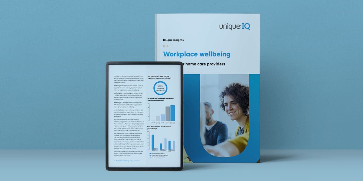 Workplace wellbeing guide on table next to tablet