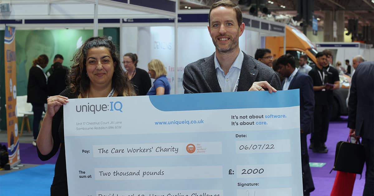 Unique IQ CEO David Lynes presents Ayesha Sadiq of the Care Workers Charity with a large cheque representing a £2000 donation