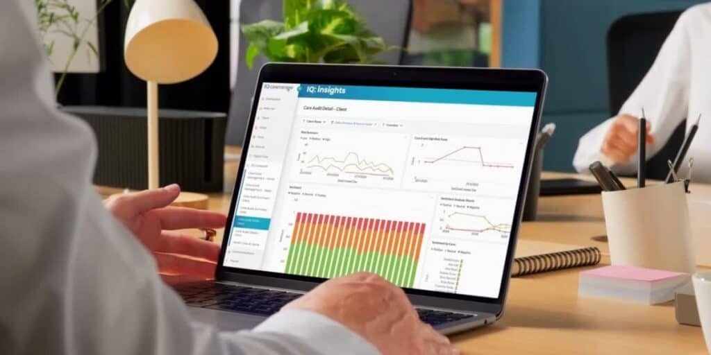 Care worker using care management software to evidence HIQA compliance